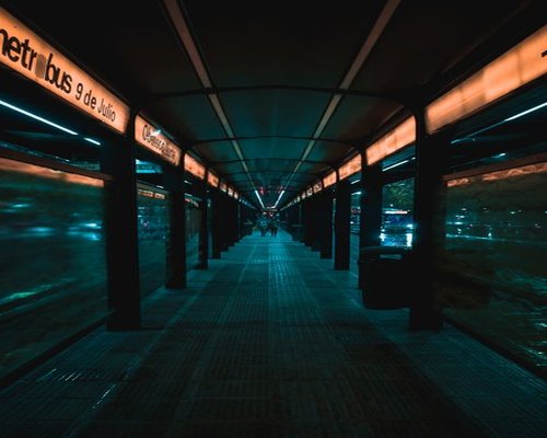 Commuters walking calmly outside a Metrobús station
